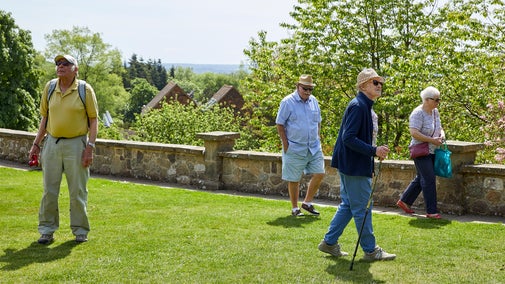 A group of visitors strolling on the Terrace Lawn at Chartwell, Kent